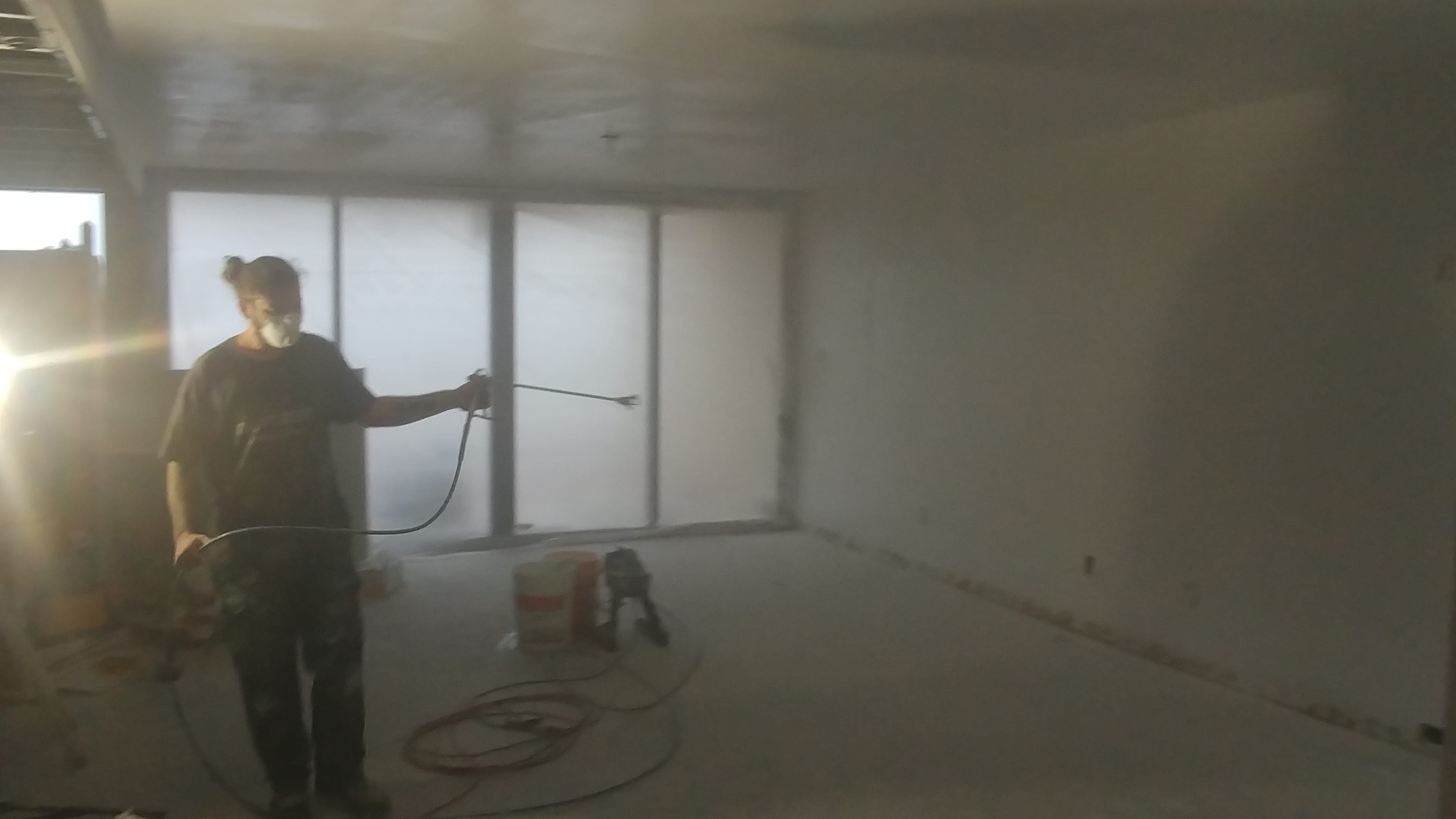 Contractors On Call painter rolling a fresh coat on an interior wall in St. Petersburg